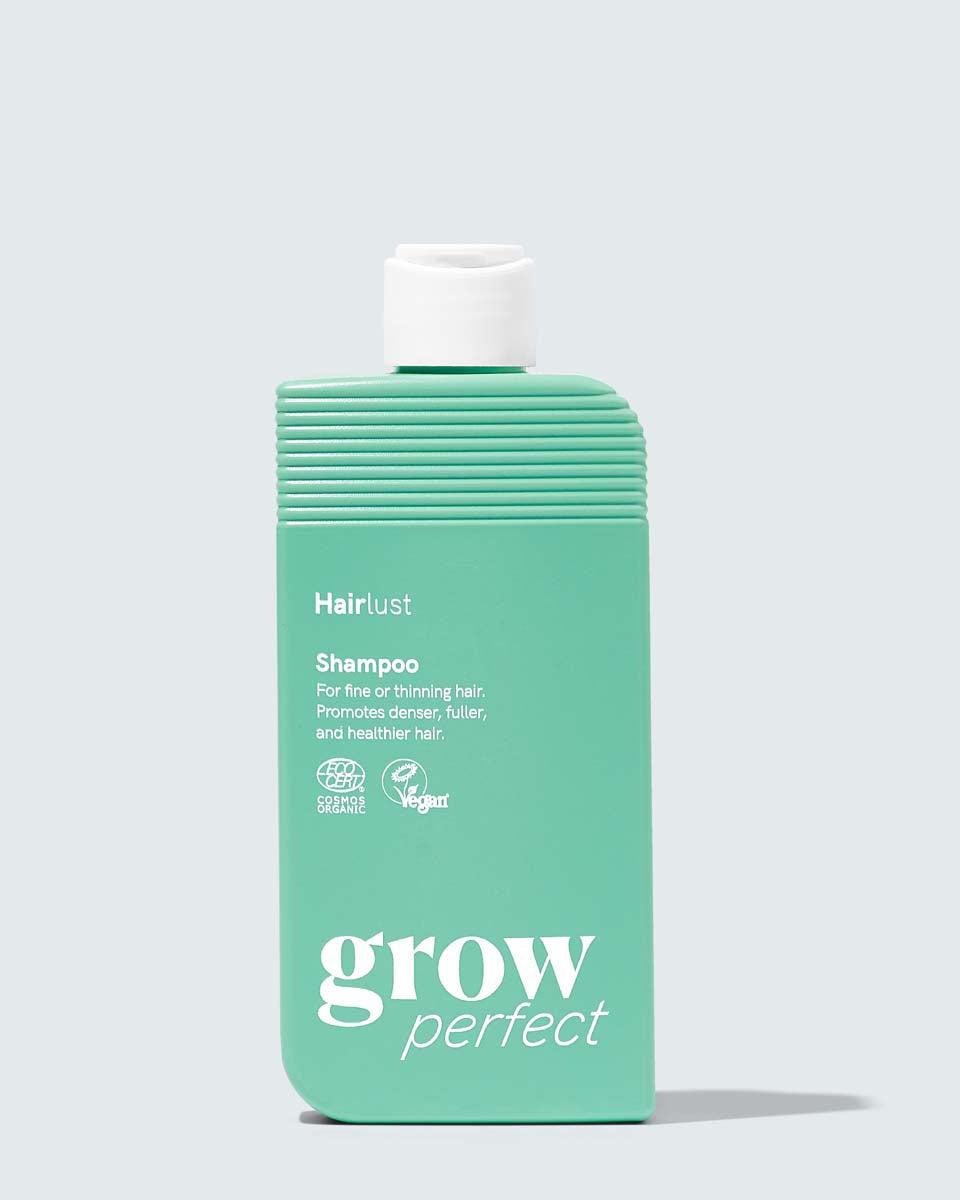 Hairlust Grow Perfect Shampoo flaske mot lys bakgrunn
